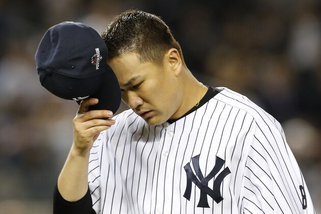 New York Yankees starting pitcher Masahiro Tanaka removes his cap as he leaves the mound in the fifth inning of the American League wild card baseball game against the Houston Astros at Yankee Stadium in New York, Tuesday, Oct. 6, 2015.  (AP Photo/Kathy Willens)