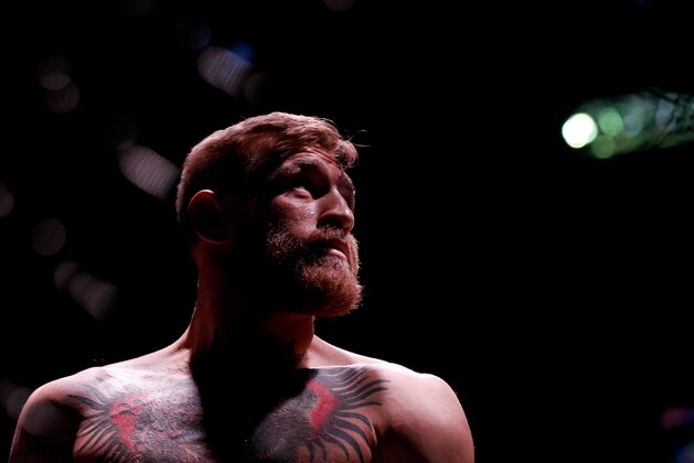 Conor McGregor looks on before fighting Jose Aldo in a featherweight  championship mixed martial arts bout at UFC 194, Saturday, Dec. 12, 2015, in Las Vegas. (AP Photo/John Locher)