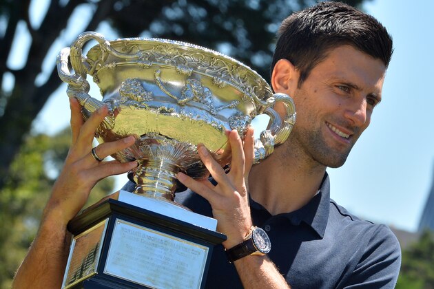 Novak Djokovic of Serbia poses for a photograph with his sixth Australian Open tennis trophy in the Government House gardens in Melbourne on February 1, 2016.   AFP PHOTO / PAUL CROCK --IMAGE RESTRICTED TO EDITORIAL USE - STRICTLY NO COMMERCIAL USE-- / AFP / PAUL CROCK        (Photo credit should read PAUL CROCK/AFP/Getty Images)