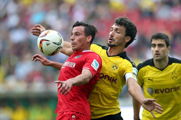 Dortmund's defender Mats Hummels (R) vies with Hanover's midfielder Edgar Prib during the German first division Bundesliga football match Hannover 96 v Borussia Dortmund, in Hannover, on September 12, 2015.  AFP PHOTO /  RONNY HARTMANN  RESTRICTIONS: DURING MATCH TIME: DFL RULES TO LIMIT THE ONLINE USAGE TO 15 PICTURES PER MATCH AND FORBID IMAGE SEQUENCES TO SIMULATE VIDEO.  == RESTRICTED TO EDITORIAL USE == FOR FURTHER QUERIES PLEASE CONTACT DFL DIRECTLY AT + 49 69 650050.        (Photo credit should read RONNY HARTMANN/AFP/Getty Images)