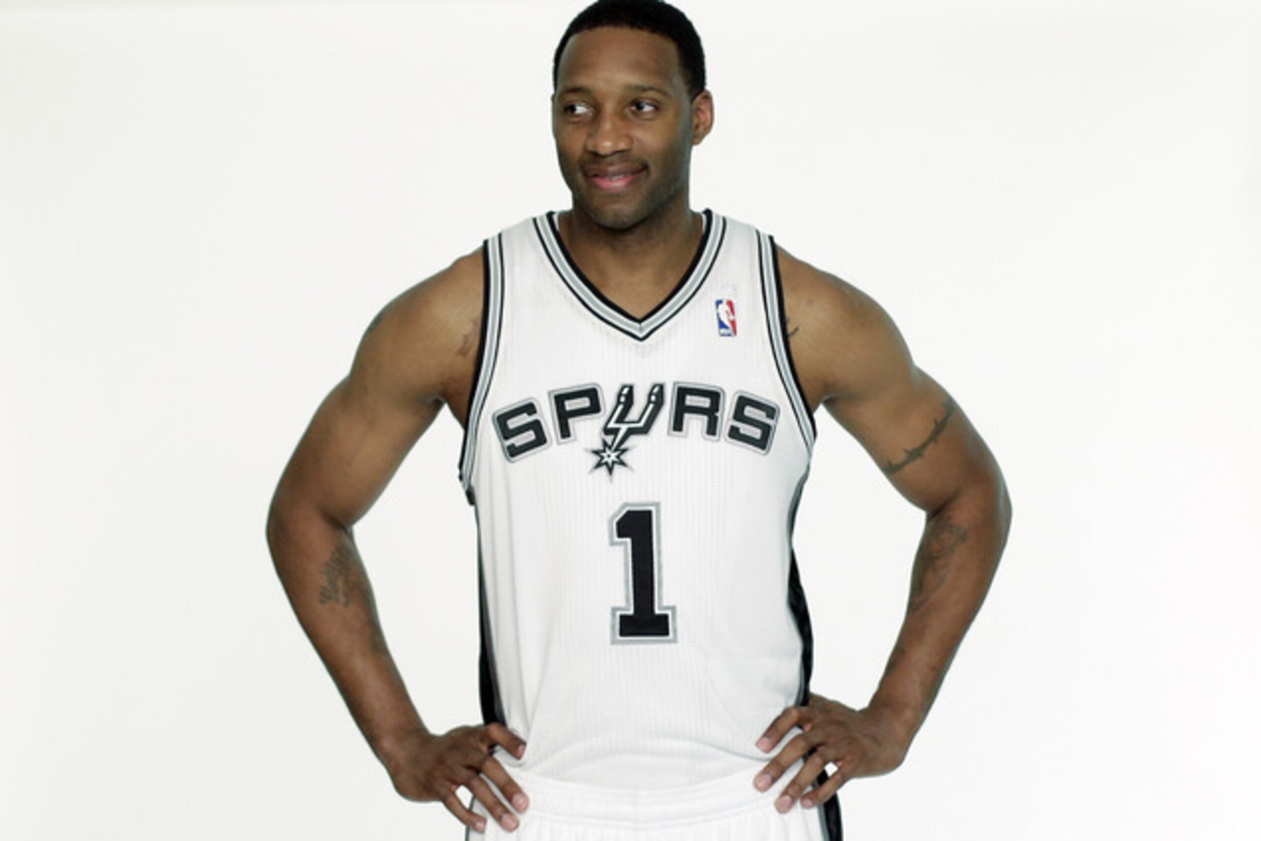 San Antonio Spurs' Tracy McGrady waits to be photographed in his new Spurs basketball uniform on Wednesday, April 17, 2013, in San Antonio. McGrady was signed by the Spurs this week.  (AP Photo/Eric Gay)