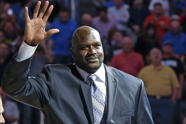 Former NBA basketball player Shaquille O'Neal waves to fans as he is honored  during an NBA basketball game between the Orlando Magic and the Detroit Pistons after he was inducted in the Magic Hall of Fame, Friday, March 27, 2015, in Orlando, Fla. Selected by Orlando with the first overall pick of the 1992 NBA Draft, O'Neal spent four seasons with the Magic from 1992-96. (AP Photo/John Raoux)