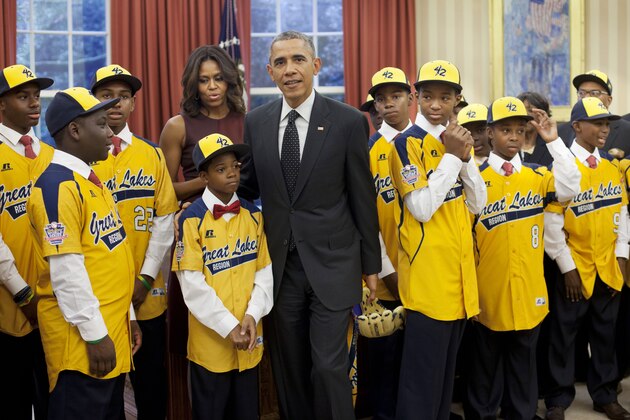President Barack Obama and first lady Michelle Obama meet with members of the Jackie Robinson West All Stars little league team in the Oval Office of the White House in Washington, Thursday, Nov. 6, 2014. The little league team, from the South Side of Chicago, won the national championship but lost the world title game to South Korean in August, are visiting Washington and the White House at the invitation of the President. (AP Photo/Pablo Martinez Monsivais)