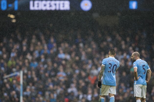 Manchester City's Pablo Zabaleta, right, and Nicolas Otamendi stand on the pitch during the English Premier League soccer match between Manchester City and Leicester City at the Etihad Stadium in Manchester, England, Saturday Feb. 6, 2016. (AP Photo/Jon Super)
