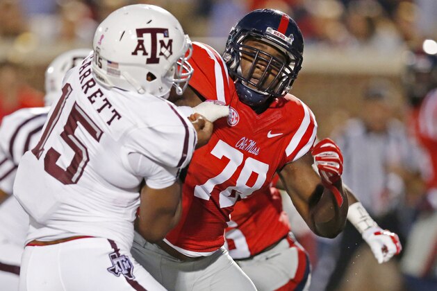 FILE - In this Oct. 24, 2015, file photo, Texas A&M defensive lineman Myles Garrett (15) is locked up by Mississippi offensive lineman Laremy Tunsil (78) during the first half of their NCAA college football game in Oxford, Miss. Some of the Southeastern Conference’s best players this season are Vadal Alexander, Ryan Kelly and Laremy Tunsil. If one or more of those names doesn’t ring a bell, that’s not surprising. They are part of an obscure group to most fans, but well-known to teammates, opponents and coaches.The three critical players are offensive linemen _ college football’s anonymous units that clear the way for more well-known players. (AP Photo/Rogelio V. Solis, File)
