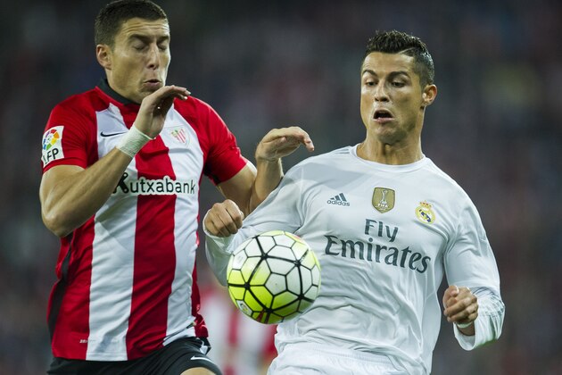 BILBAO, SPAIN - SEPTEMBER 23: Cristiano Ronaldo (R) of Real Madrid CF duels for the ball with Oscar De Marcos of Athletic Club Bilbao during the La Liga match between Athletic Club Bilbao and Real Madrid CF at San Mames Stadium on September 23, 2015 in Bilbao, Spain.  (Photo by Juan Manuel Serrano Arce/Getty Images)