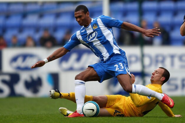 WIGAN, UNITED KINGDOM - APRIL 19: Marcus Bent of Wigan in action with Alan Hutton of Tottenham Hotspur during the Barclays Premier League match between Wigan and  Tottenham Hotspur at the JJB Stadium on April 19, 2008 in Wigan, England.  (Photo by Clive Brunskill/Getty Images)