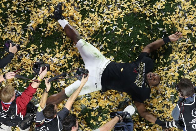 Jan 11, 2016; Glendale, AZ, USA; Alabama Crimson Tide linebacker Reggie Ragland celebrates with snow angle in the middle of the field following their 45-40 victory over the Clemson Tigers in the 2016 CFP National Championship at University of Phoenix Stadium. Mandatory Credit: Erich Schlegel-USA TODAY Sports