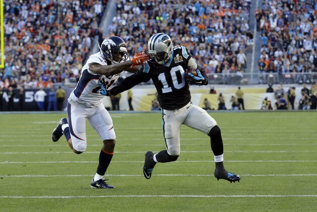 Denver Broncos’ Aqib Talib (21) tackles Carolina Panthers’ Corey Brown (10) after he caught a pass during the first half of the NFL Super Bowl 50 football game Sunday, Feb. 7, 2016, in Santa Clara, Calif. Talib was penalized for grabbing Brown's facemask.  (AP Photo/Jeff Chiu)