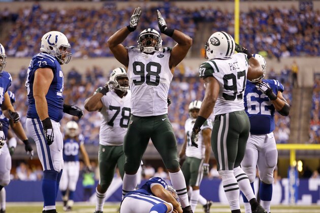 New York Jets outside linebacker Quinton Coples (98) stands over Indianapolis Colts quarterback Andrew Luck (12) after he sacked him during an NFL football game in Indianapolis, Monday, Sept. 21, 2015. (Jeff Haynes/AP Images for Panini)