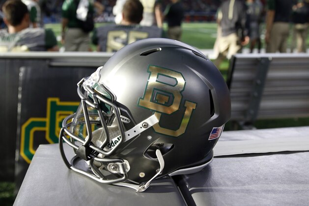 A Baylor helmet is placed along the team bench area during an NCAA college football game against Texas Tech Saturday, Oct. 3, 2015, in Arlington, Texas. (AP Photo/Roger Steinman)