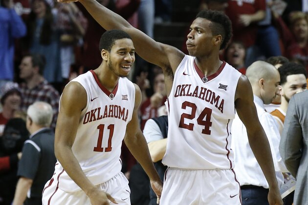 Oklahoma guard Isaiah Cousins (11) and guard Buddy Hield (24) celebrate in the second half of an NCAA college basketball game against Texas in Norman, Okla., Monday, Feb. 8, 2016. Oklahoma won 63-60. (AP Photo/Sue Ogrocki)