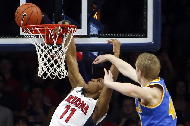 Arizona guard Allonzo Trier (11) is fouled by UCLA center Thomas Welsh during the first half of an NCAA college basketball game Friday, Feb 12, 2016, in Tucson, Ariz. (AP Photo/Rick Scuteri)