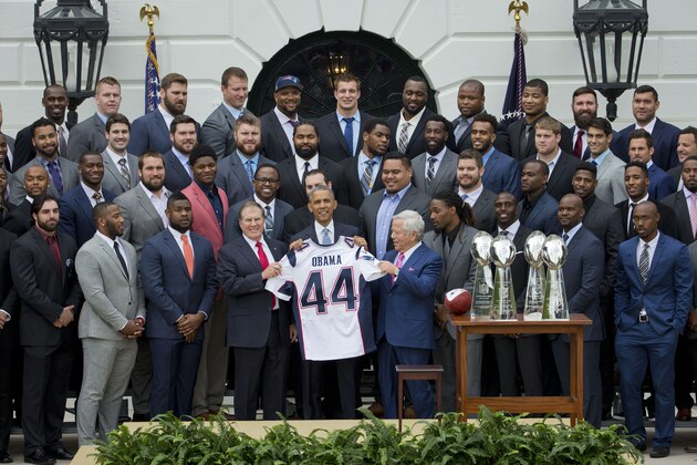 President Barack Obama holds a New England Patriots team jersey, flanked by New England Patriots coach Bill Belichick, left, and team owner Robert Kraft, right, as he welcomed the Super Bowl Champion New England Patriots, Thursday, April 23, 2015, on the South Lawn of the White House in Washington, to honor the team and their Super Bowl XLIX victory. (AP Photo/Pablo Martinez Monsivais)