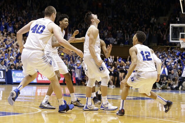 Duke's Grayson Allen, center, reacts with Marshall Plumlee (40), Brandon Ingram and Derryck Thornton (12) following Allen's game winning shot as time expired to beat Virginia in an NCAA college basketball game in Durham, N.C., Saturday, Feb. 13, 2016. Duke won 63-62. (AP Photo/Gerry Broome)
