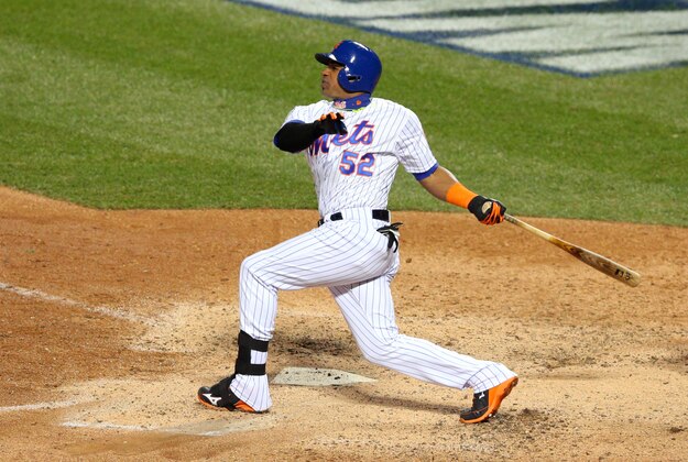 Oct 30, 2015; New York City, NY, USA; New York Mets center fielder Yoenis Cespedes drives in a run with a sacrifice fly against the Kansas City Royals in the 6th inning in game three of the World Series at Citi Field. Mandatory Credit: Brad Penner-USA TODAY Sports
