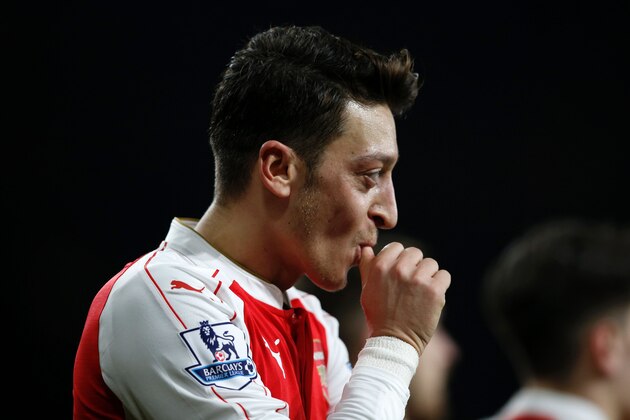 Arsenal's German midfielder Mesut Ozil celebrates after scoring their second goal during the English Premier League football match between Arsenal and Bournemouth at the Emirates Stadium in London on December 28, 2015. / AFP / ADRIAN DENNIS        (Photo credit should read ADRIAN DENNIS/AFP/Getty Images)