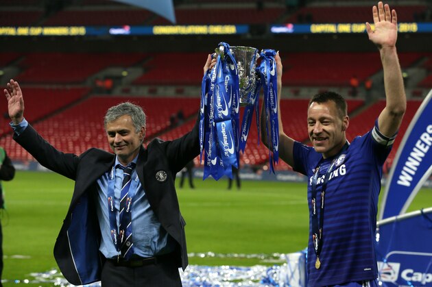 Chelsea's head coach Jose Mourinho, left and Chelsea's John Terry hold the trophy  after they won the English League Cup Final between Tottenham Hotspur and Chelsea at Wembley stadium in London, Sunday, March, 1, 2015. Chelsea won the match 2-0. (AP Photo/Tim Ireland)