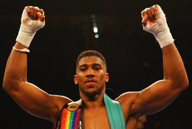 LONDON, ENGLAND - DECEMBER 12:  Anthony Joshua celebrates victory over Dillian Whyte with his belts after the British and Commonwealth heavyweight title contest at The O2 Arena on December 12, 2015 in London, England.  (Photo by Richard Heathcote/Getty Images)
