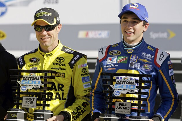 Matt Kenseth, left, and Chase Elliott hold their trophies after they qualified for the top two starting positions in the NASCAR Daytona 500 auto race at Daytona International Speedway, Sunday, Feb. 14, 2016, in Daytona Beach, Fla. (AP Photo/John Raoux)