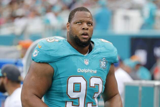 Miami Dolphins defensive tackle Ndamukong Suh (93) walks the sidelines during the first half of an NFL football game against the New England Patriots, Sunday, Jan. 3, 2016 in Miami Gardens, Fla. (AP Photo/Wilfredo Lee)