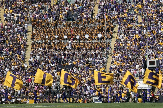 LSU cheerleaders carry flags across the end zone after the Tigers scored a touchdown against Kentucky in Baton Rouge, La., Saturday, Oct. 1, 2011. LSU defeated Kentucky 35-7in an NCAA college football game. (AP Photo/Bill Haber)