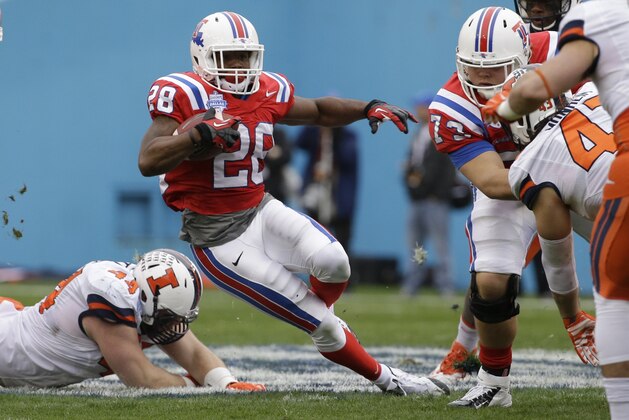 Louisiana Tech running back Kenneth Dixon (28) beats a tackle against Illinois defensive lineman Austin Teitsma (44) and finds a hole to run as Louisiana Tech Kirby Wixson (73) blocks Illinois Mason Monheim (43) during the first half of the Heart of Dallas Bowl NCAA college football game Friday, Dec. 26, 2014, in Dallas. (AP Photo/LM Otero)