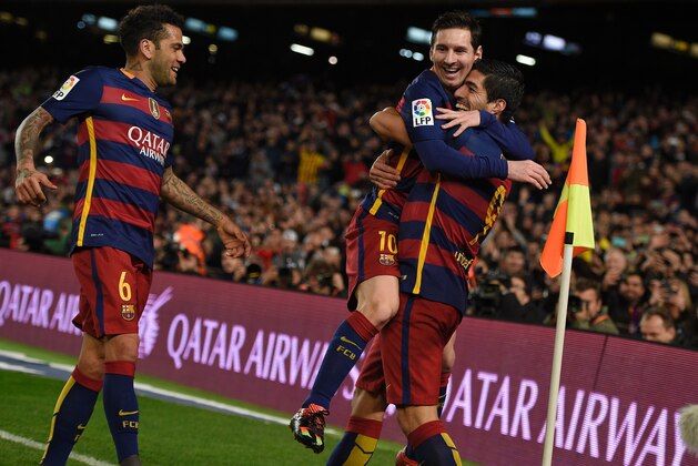 Barcelona's Uruguayan forward Luis Suarez (R) celebrates a goal with Barcelona's Argentinian forward Lionel Messi (C) and Barcelona's Brazilian defender Dani Alves during the Spanish league football match FC Barcelona vs RC Celta de Vigo at the Camp Nou stadium in Barcelona on February 14, 2016.

 / AFP / LLUIS GENE        (Photo credit should read LLUIS GENE/AFP/Getty Images)