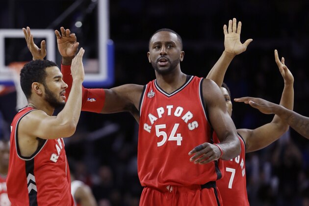 Toronto Raptors forward Patrick Patterson (54) and guard Cory Joseph celebrate during the closing minutes of their 103-89 win over the Detroit Pistons during the second half of an NBA basketball game, Monday, Feb. 8, 2016 in Auburn Hills, Mich. (AP Photo/Carlos Osorio)