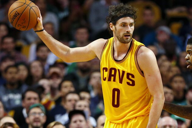 Cleveland Cavaliers' Kevin Love works on Boston Celtics' Amir Johnson during the second quarter of a NBA basketball game in Boston Tuesday, Dec. 15, 2015. (AP Photo/Winslow Townson)