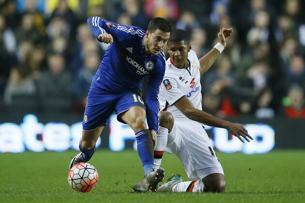 Milton Keynes Dons’ Jordan Spence, right, competes for the ball with Chelsea's Eden Hazard during the English FA Cup fourth round soccer match between Milton Keynes Dons and Chelsea at Stadium mk in Milton Keynes, England, Sunday, Jan. 31, 2016. (AP Photo/Kirsty Wigglesworth)