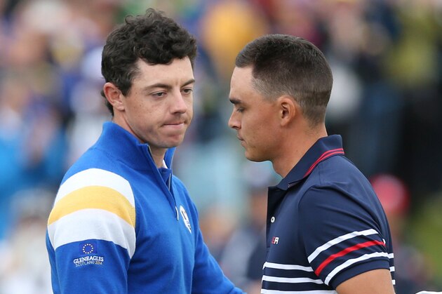 Europe’s Rory McIlroy, left, shakes hands with Rickie Fowler of the US, after winning his match on the 14th hole during the singles match on the final day of the Ryder Cup golf tournament, at Gleneagles, Scotland, Sunday, Sept. 28, 2014. (AP Photo/Peter Morrison)