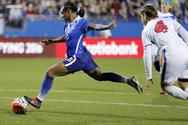 United States forward Crystal Dunn (16) attempts a shot on goal as Puerto Rico midfielder Viviana Fiol Vilches (4) defends during the first half of a women's Olympic qualifying soccer match, Monday, Feb. 15, 2016 in Frisco, Texas. (AP Photo/Brandon Wade)