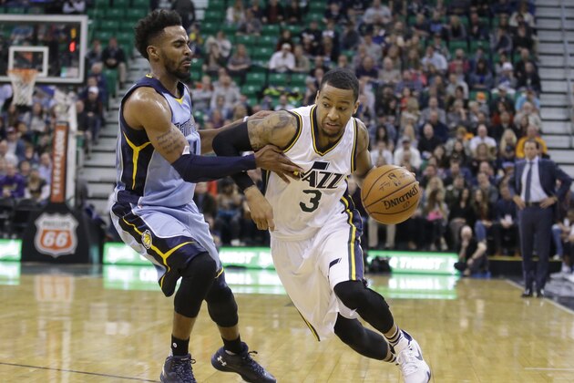 Utah Jazz guard Trey Burke (3) drives around Memphis Grizzlies guard Mike Conley (11) during the second half of an NBA basketball game Saturday, Jan. 2, 2016, in Salt Lake City. The Jazz won 92-87 in overtime. (AP Photo/Rick Bowmer)