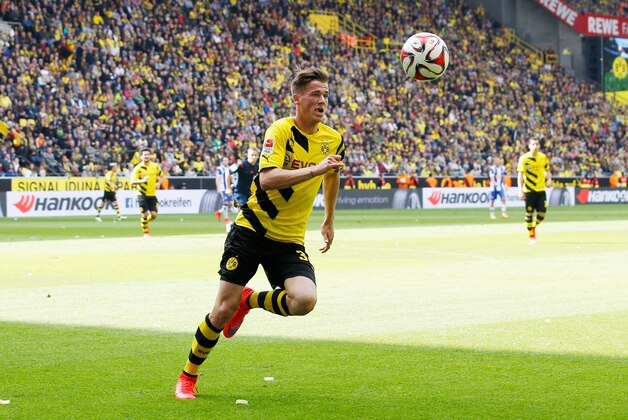 DORTMUND, GERMANY - MAY 09:  Erik Durm of Dortmund runs with the ball during the Bundesliga match between Borussia Dortmund and Hertha BSC at Signal Iduna Park on May 9, 2015 in Dortmund, Germany.  (Photo by Boris Streubel/Getty Images)