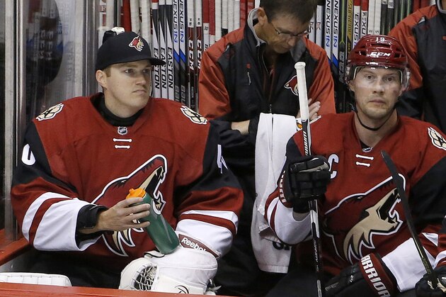 Arizona Coyotes backup goalie Nathan Schoenfeld, left, signed to the team only hours prior to the game due to an injury to goalie Anders Lindback, sits next to Shane Doan during the second period of an NHL hockey game Monday, Feb. 15, 2016, in Glendale, Ariz. The Coyotes defeated the Canadiens 6-2. (AP Photo/Ross D. Franklin)