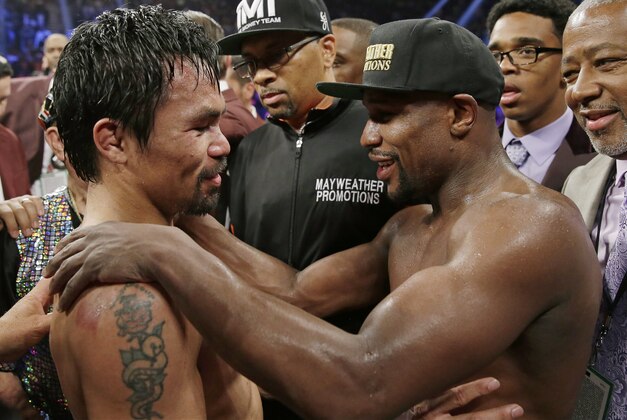 FILE - This May 2, 2015 file photo shows Manny Pacquiao, from the Philippines, left, and Floyd Mayweather Jr., embrace in the ring at the finish of their welterweight title fight in Las Vegas. Boxing fans across the country or at least their lawyers are calling the hyped-up fight between Pacquiao and Mayweather a fraud. Some 31 class action lawsuits had been filed through Friday alleging primarily the same thing: that Pacquiao's pre-existing shoulder injury should have been disclosed to fans ahead of time. (AP Photo/Isaac Brekken,File)
