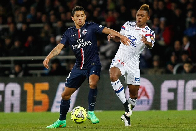Paris Saint Germain's Brazilian defender Marquinhos, left, battles for the ball with Lyon's Cameroonian forward Clinton N'Jie during the League One soccer match between Lyon and Paris Saint-Germain, at the Gerland Stadium, in Lyon, central France, Sunday Feb. 8, 2015. (AP Photo/Claude Paris)
