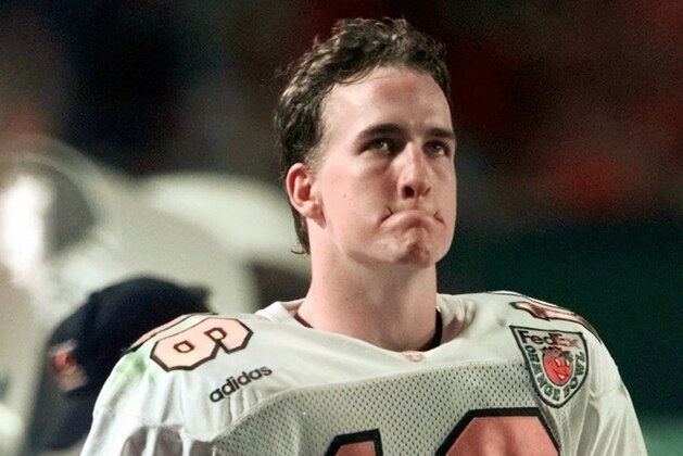 Tennessee quarterback Peyton Manning grimaces on the sideline in the closing moments of their 42-17 loss to Nebraska in the Orange Bowl at Pro Player Stadium in Miami, Fla., Friday, Jan. 2, 1998. (AP Photo/Joe Cavareta)