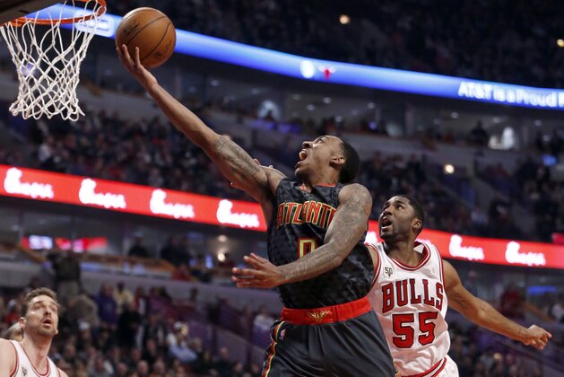 Atlanta Hawks guard Jeff Teague (0) drives to the basket past Chicago Bulls E'Twaun Moore (55) during the second half of an NBA basketball game Wednesday, Feb. 10, 2016, in Chicago. (AP Photo/Charles Rex Arbogast)