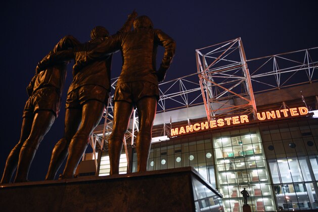 A general view outside Old Trafford stadium and 'The United Trinity' statue of former Manchester United players George Best, Denis Law, and Bobby Charlton seen ahead of the English Premier League football match between Manchester United and Burnley at Old Trafford in Manchester, north west England, on February 11, 2015.  AFP PHOTO / OLI SCARFF

RESTRICTED TO EDITORIAL USE. No use with unauthorized audio, video, data, fixture lists, club/league logos or live services. Online in-match use limited to 45 images, no video emulation. No use in betting, games or single club/league/player publications.        (Photo credit should read OLI SCARFF/AFP/Getty Images)