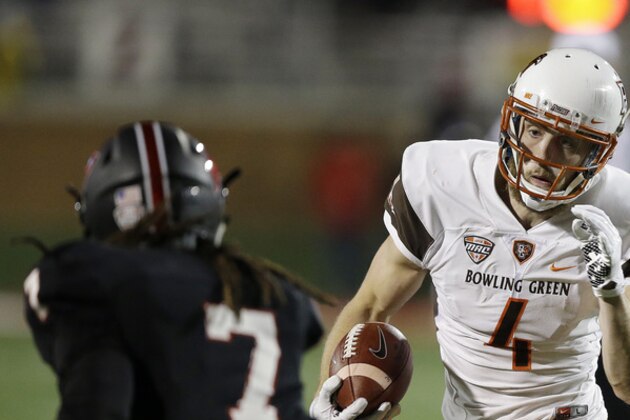 Bowling Green's Gehrig Dieter (4) runs against Ball State's Aaron Taylor (7) during the first half of an NCAA college football game Tuesday, Nov. 24, 2015, in Muncie, Ind. (AP Photo/Darron Cummings)