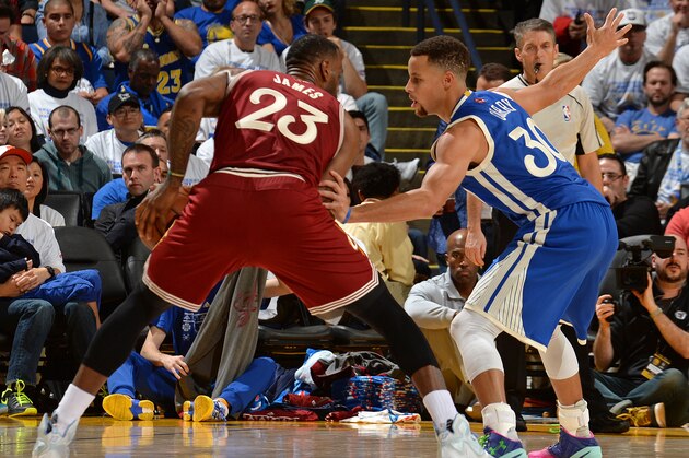 OAKLAND, CA - DECEMBER 25:  LeBron James #23 of the Cleveland Cavaliers dribbles the ball while defended by Stephen Curry #30 of the Golden State Warriors on December 25, 2015 at ORACLE Arena in Oakland, California. NOTE TO USER: User expressly acknowledges and agrees that, by downloading and or using this Photograph, user is consenting to the terms and conditions of the Getty Images License Agreement. Mandatory Copyright Notice: Copyright 2015 NBAE (Photo by Noah Graham/NBAE via Getty Images)