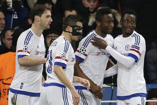 Chelsea's Nigerian midfielder John Obi Mikel (3rd L) celebrates with teammates after scoring a goal  during the Champions League round of 16 first leg football match between Paris Saint-Germain (PSG) and Chelsea FC on February 16, 2016, at the Parc des Princes stadium in Paris. AFP PHOTO / KENZO TRIBOUILLARD / AFP / KENZO TRIBOUILLARD        (Photo credit should read KENZO TRIBOUILLARD/AFP/Getty Images)