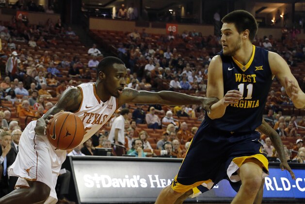 AUSTIN, TX - FEBRUARY 16: Kendal Yancy #5 of the Texas Longhorns moves with the ball against Nathan Adrian #11 of the West Virginia Mountaineers at the Frank Erwin Center on February 16, 2016 in Austin, Texas. (Photo by Chris Covatta/Getty Images)