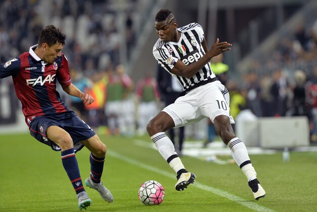 Juventus' Paul Pogba, right, takes on Bologna Alex Ferrari during a Serie A soccer match between Juventus and Bologna at the Juventus stadium, in Turin, Italy, Sunday, Oct. 4, 2015. (AP Photo/Massimo Pinca)