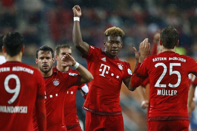 Bayern's David Alaba, center, and teammate Juan Bernat celebrate with Robert Lewandowski after scoring during the German first division Bundesliga soccer match between FC Augsburg and FC Bayern Munich at the WWK Arena in Augsburg, Germany, Sunday, Feb. 14, 2016. (AP Photo/Matthias Schrader)