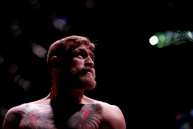 Conor McGregor looks on before fighting Jose Aldo in a featherweight  championship mixed martial arts bout at UFC 194, Saturday, Dec. 12, 2015, in Las Vegas. (AP Photo/John Locher)