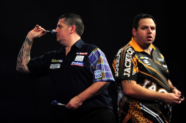 LONDON, ENGLAND - JANUARY 03:  Gary Anderson of Scotland throws as Adrian Lewis of England looks on during the final match on Day Fifteen of the 2016 William Hill PDC World Darts Championships at Alexandra Palace on January 3, 2016 in London, England.  (Photo by Dan Mullan/Getty Images)