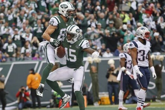 CORRECTS TO SECOND HALF NOT FIRST New York Jets wide receiver Brandon Marshall (15) and Eric Decker (87) celebrate a touchdown as New England Patriots' Leonard Johnson (34) looks on during the second half of an NFL football game, Sunday, Dec. 27, 2015, in East Rutherford, N.J. (AP Photo/Kathy Willens)